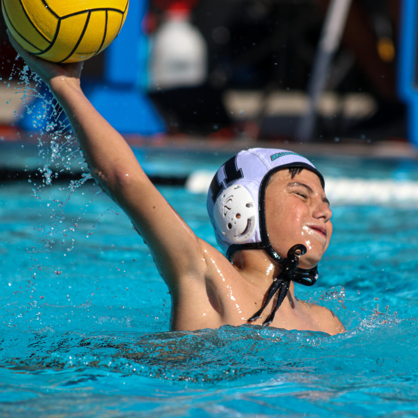 High-intensity water polo play with players in fierce competition.